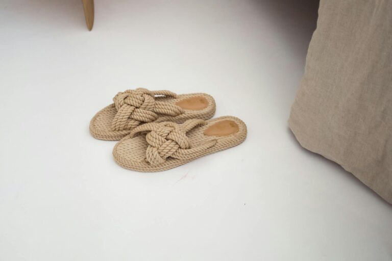 Stylish beige rope sandals on a white indoor surface, perfect for casual and comfortable wear.